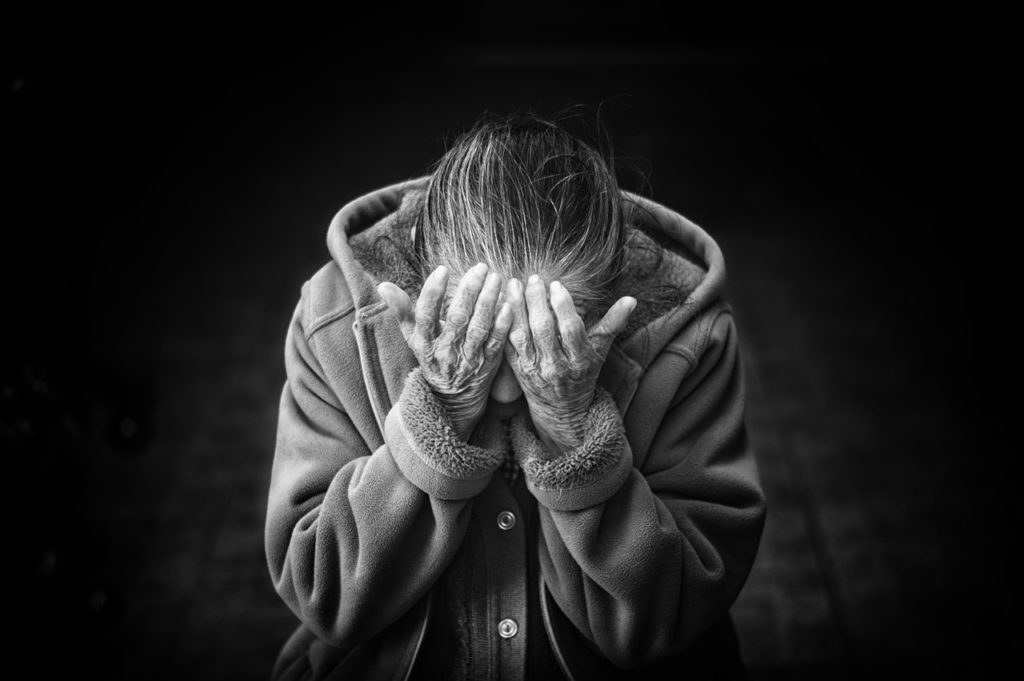 Senior woman with her head in her hands