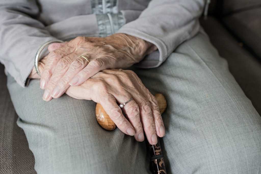 Senior hands folded in lap