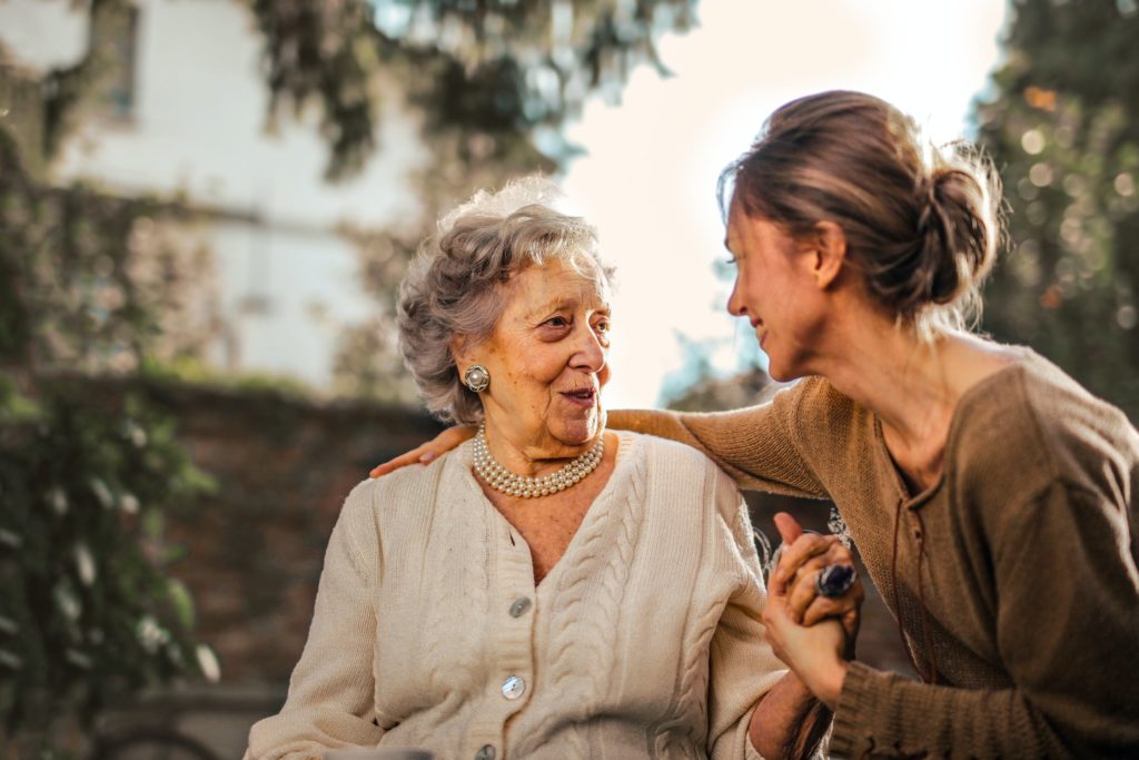 Woman holding hand of a senior