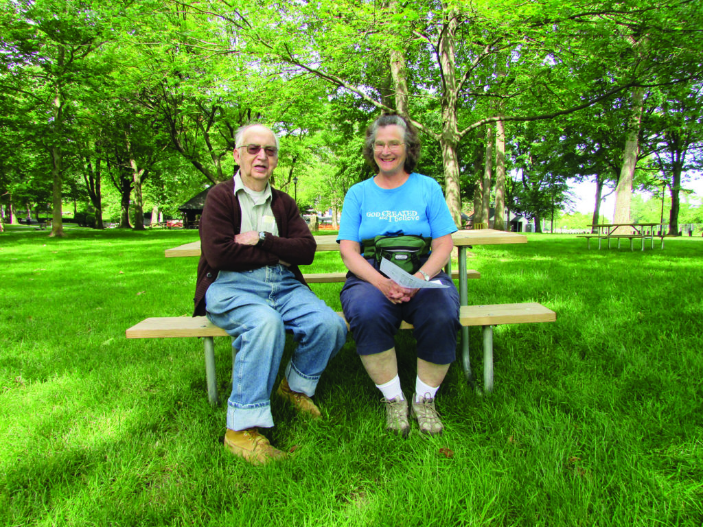 Senior couple sitting outside on bench