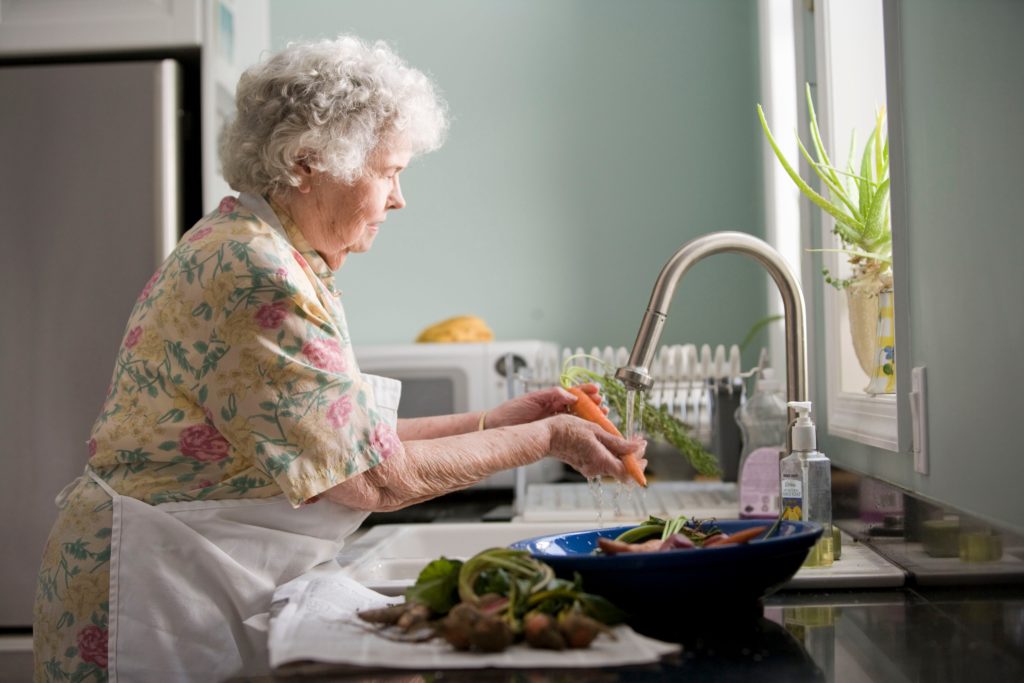 Senior washing dishes