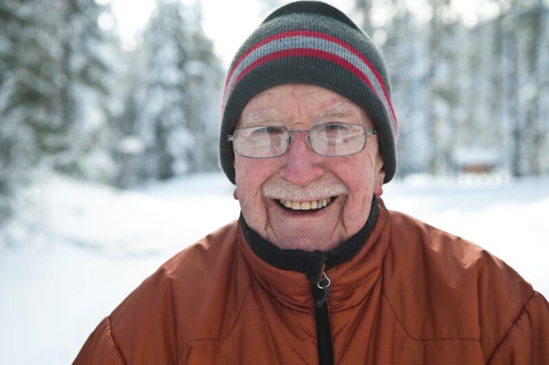 Older gentleman bundled up in the snow.