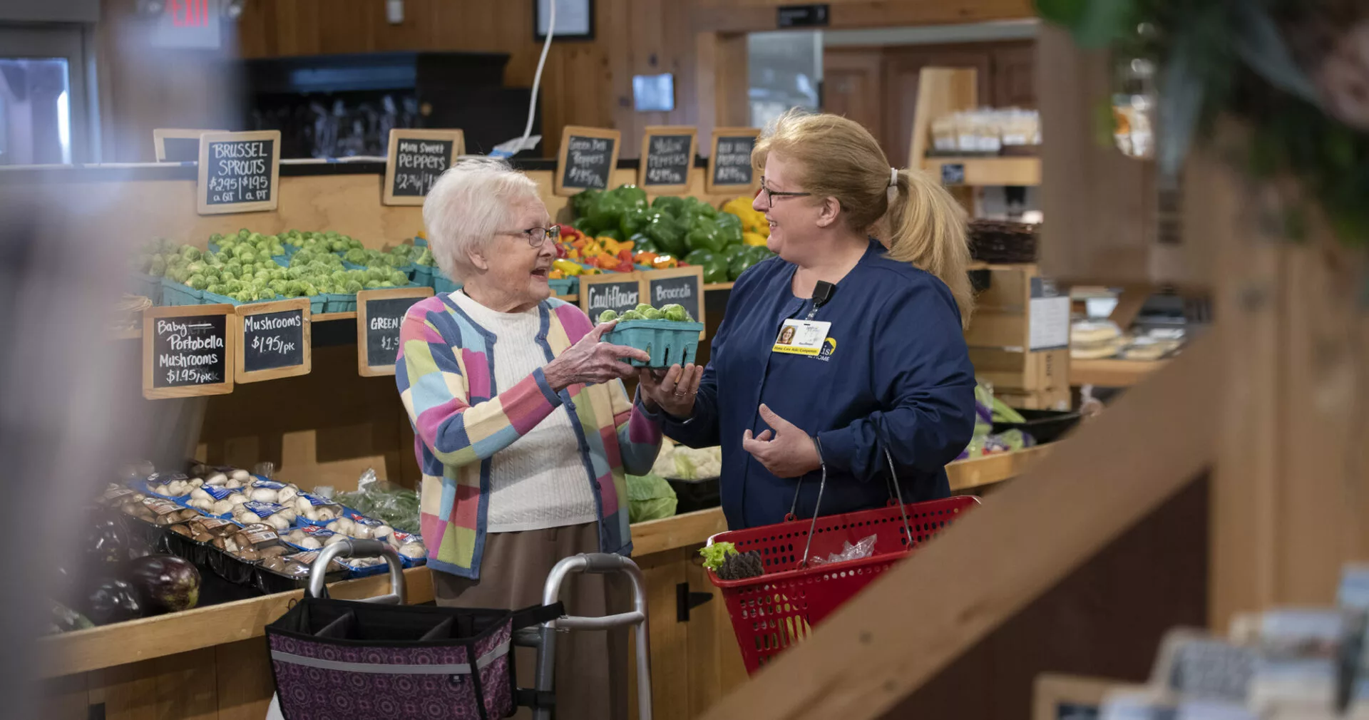 two seniors talking at kitchen table