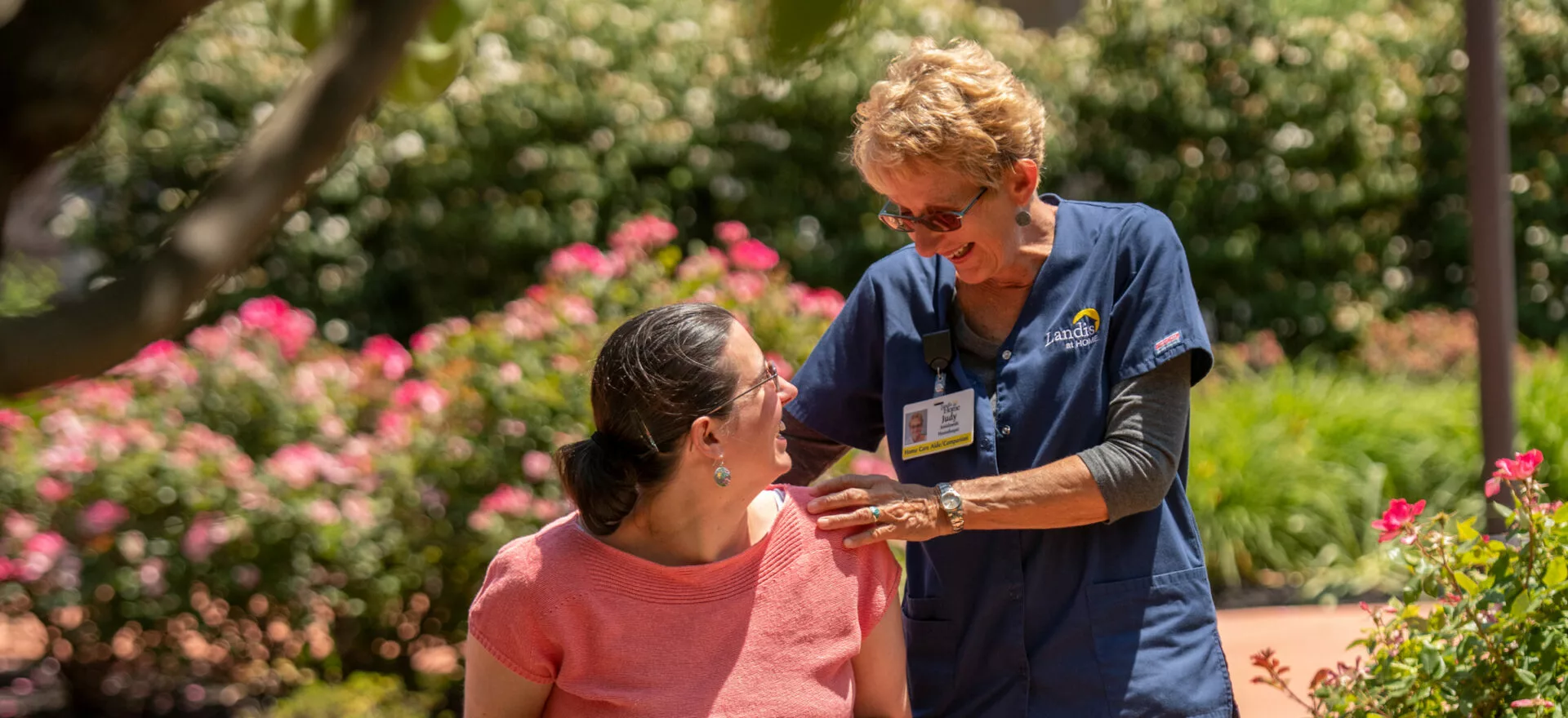 two seniors talking at kitchen table